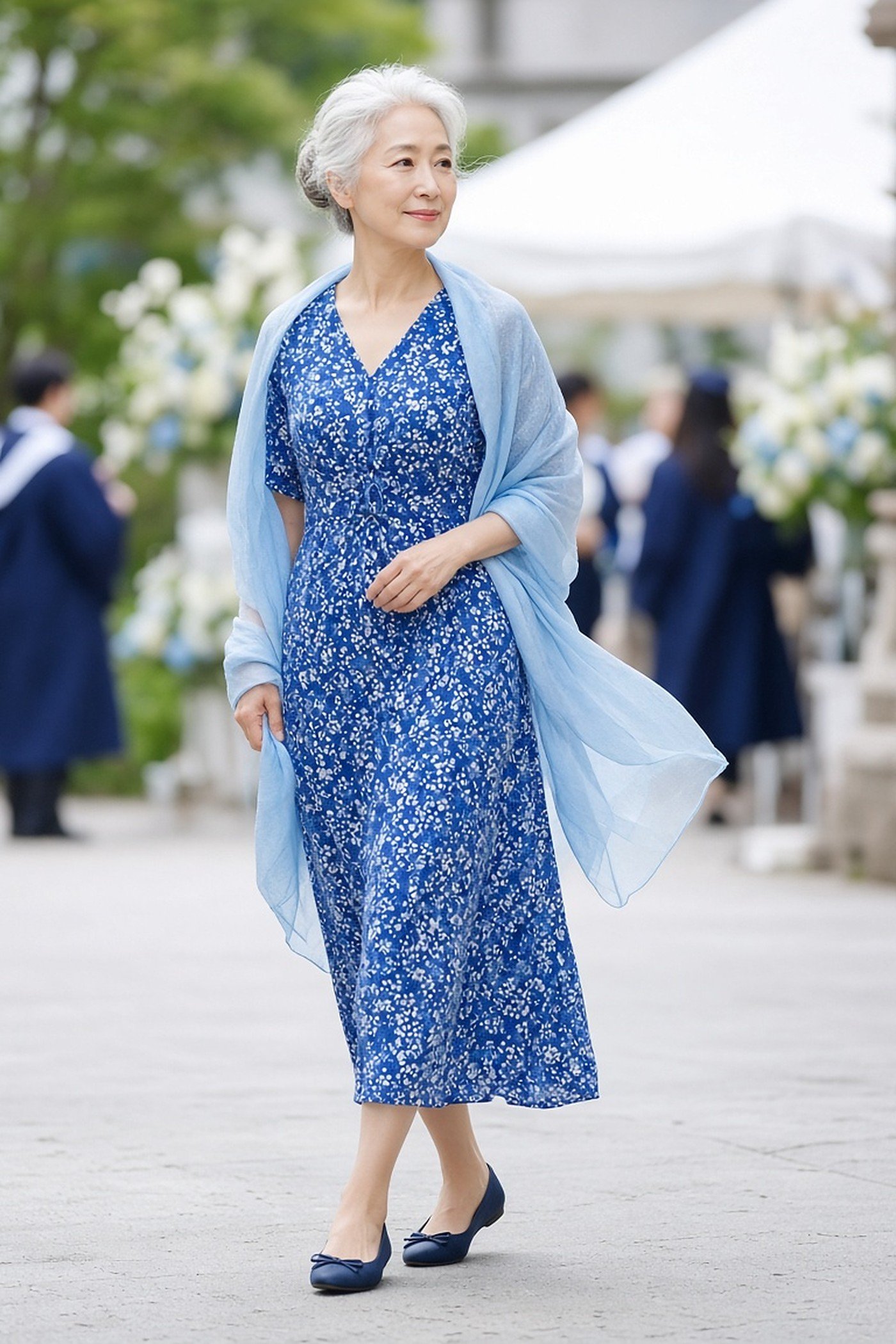 Woman over 60 in a blue print midi dress with a matching light shawl