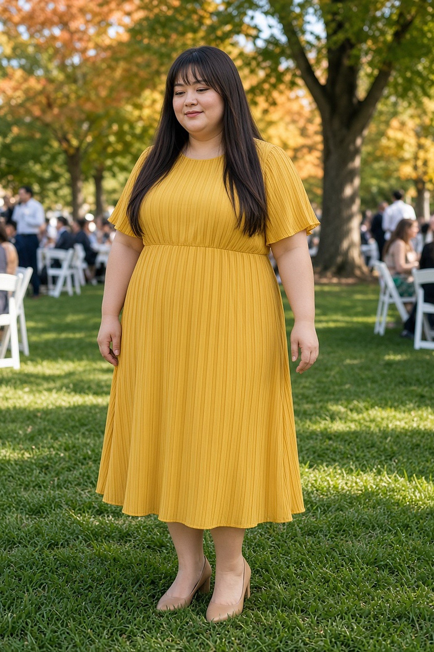 Plus-size woman in a mustard pleated midi dress at a daytime wedding